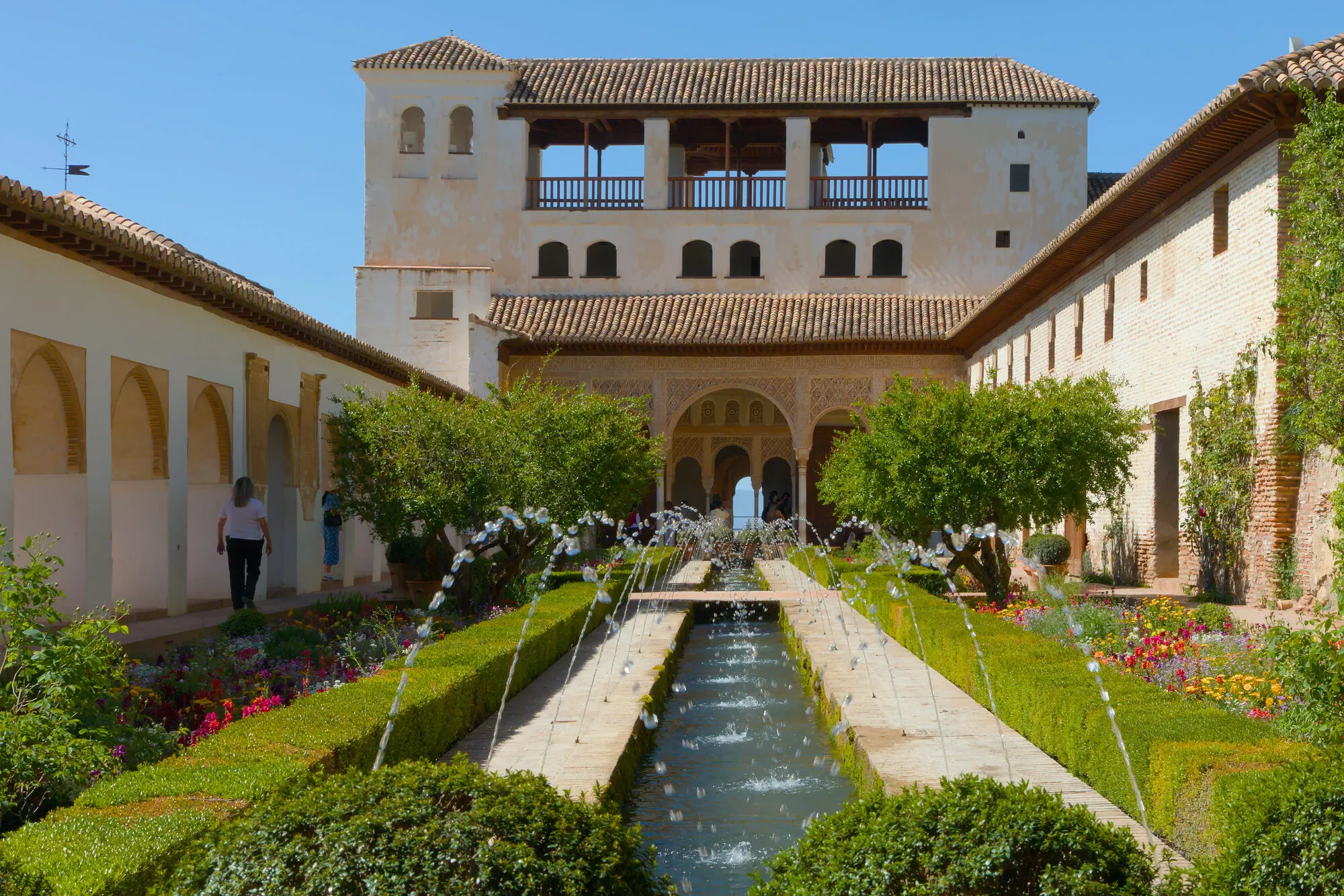 Water channel and fountains lined with hedges and cypress at the Patio de la Acequia in the Generalife, Granada