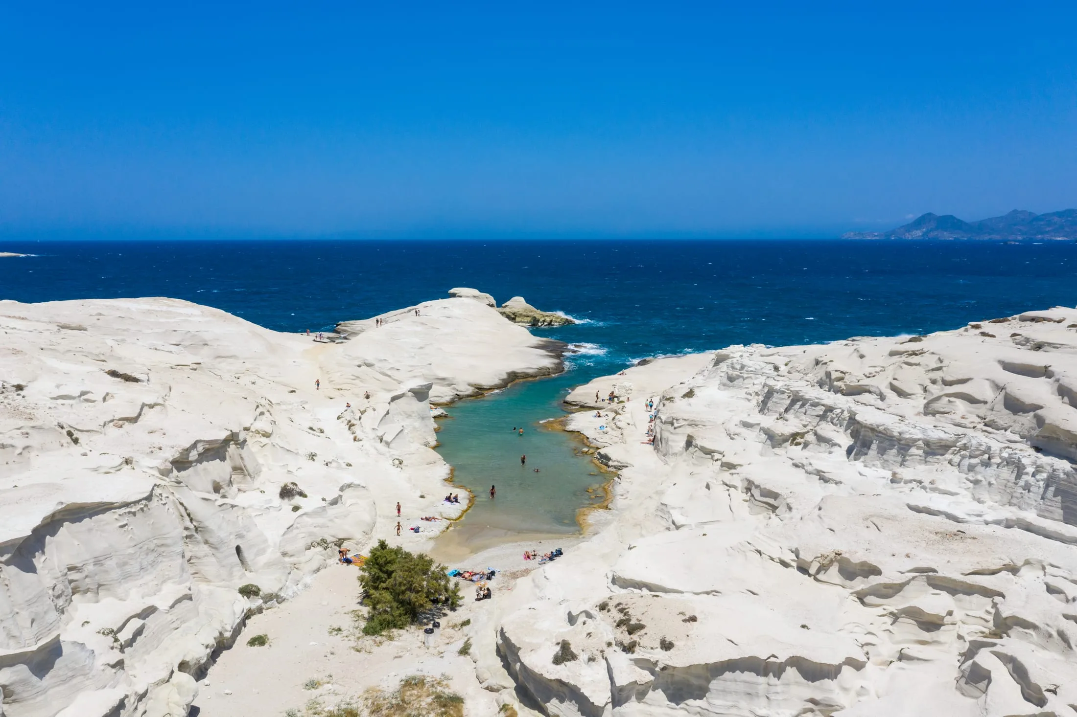 The white volcanic rock and turquoise water of Sarakiniko beach on Milos, Greece