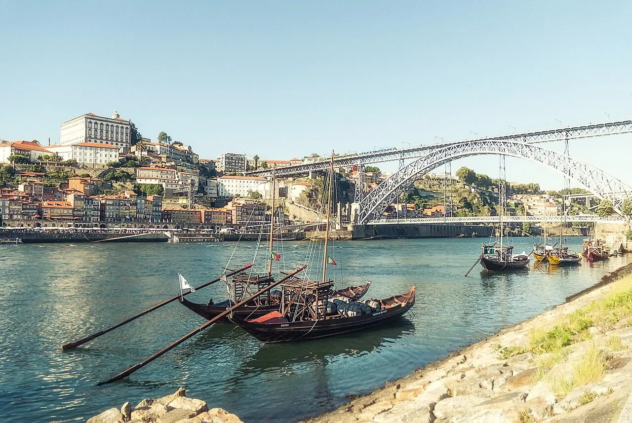 The Dom Luis I bridge and the Douro river with the Ribeira waterfront and rabelo boats in Porto, Portugal