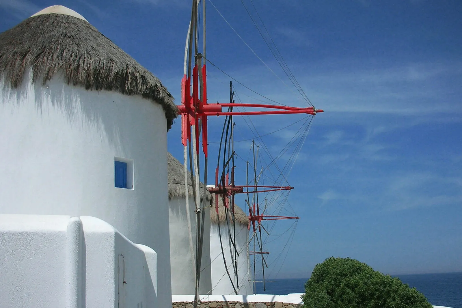 The whitewashed windmills of Mykonos above the town and the Aegean