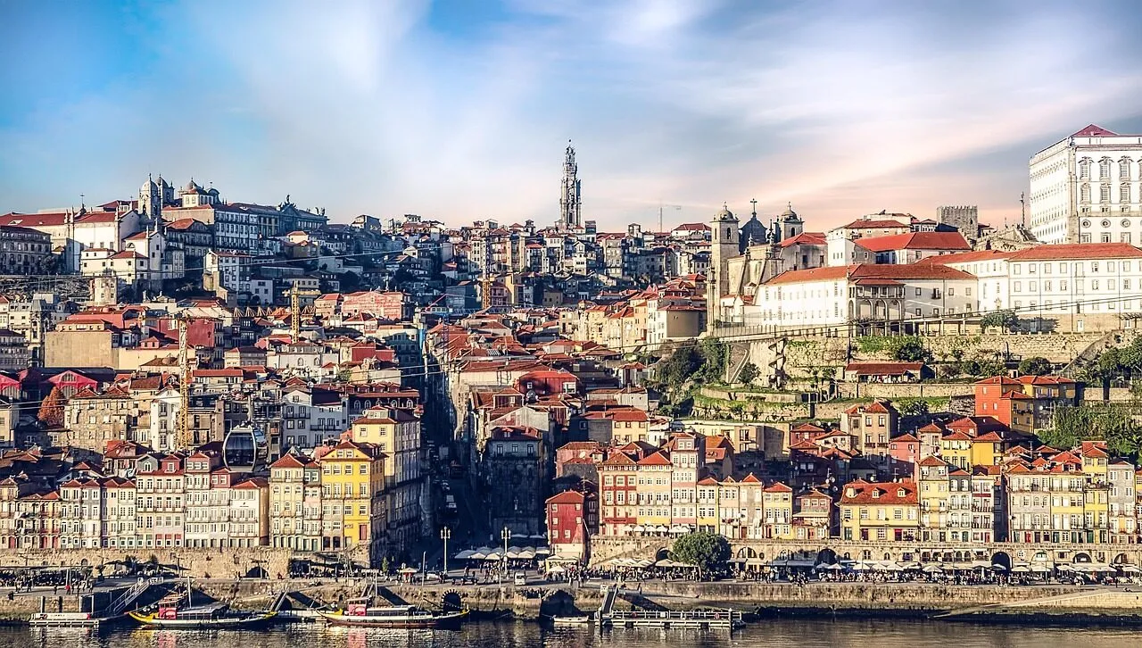 The Clerigos Tower rising above the rooftops of Porto at golden hour
