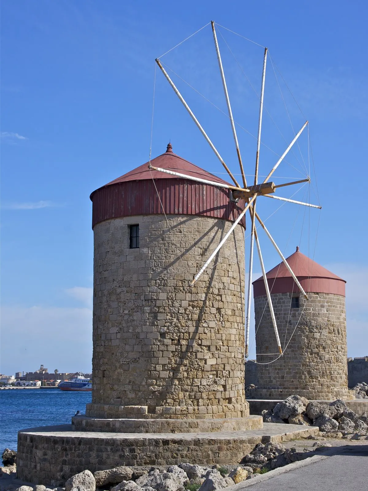 The restored windmills on the Mandraki harbour waterfront in Rhodes, Greece