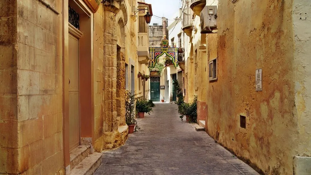 A narrow traditional street with balconies in Valletta, Malta